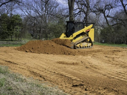 Compact track loader piling dirt.