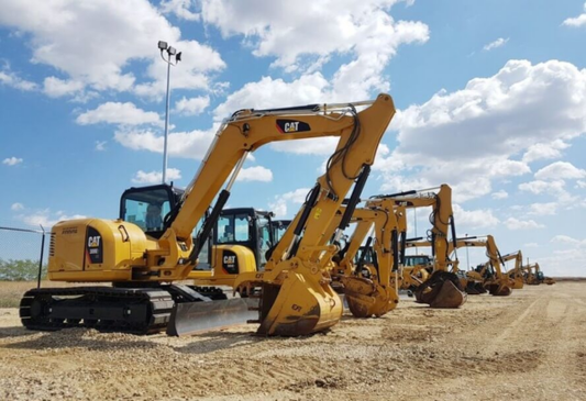 Line up of used Cat excavators.