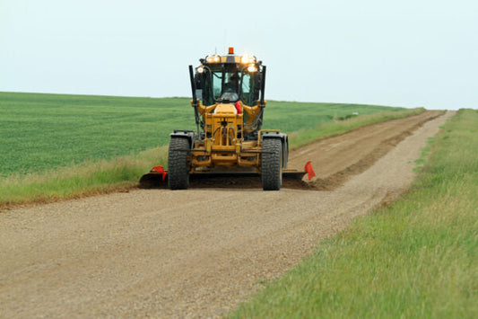 used motor grader grading country gravel road